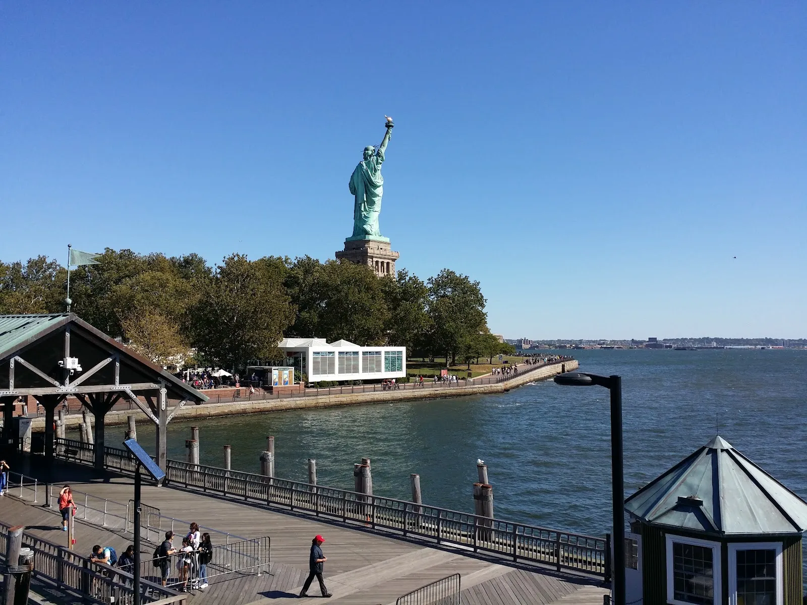 Iconic Statue of Liberty towering over harbor waters