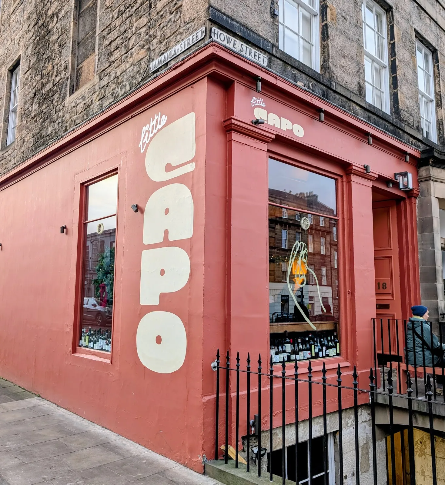 Vibrant red Little Capo exterior at street corner