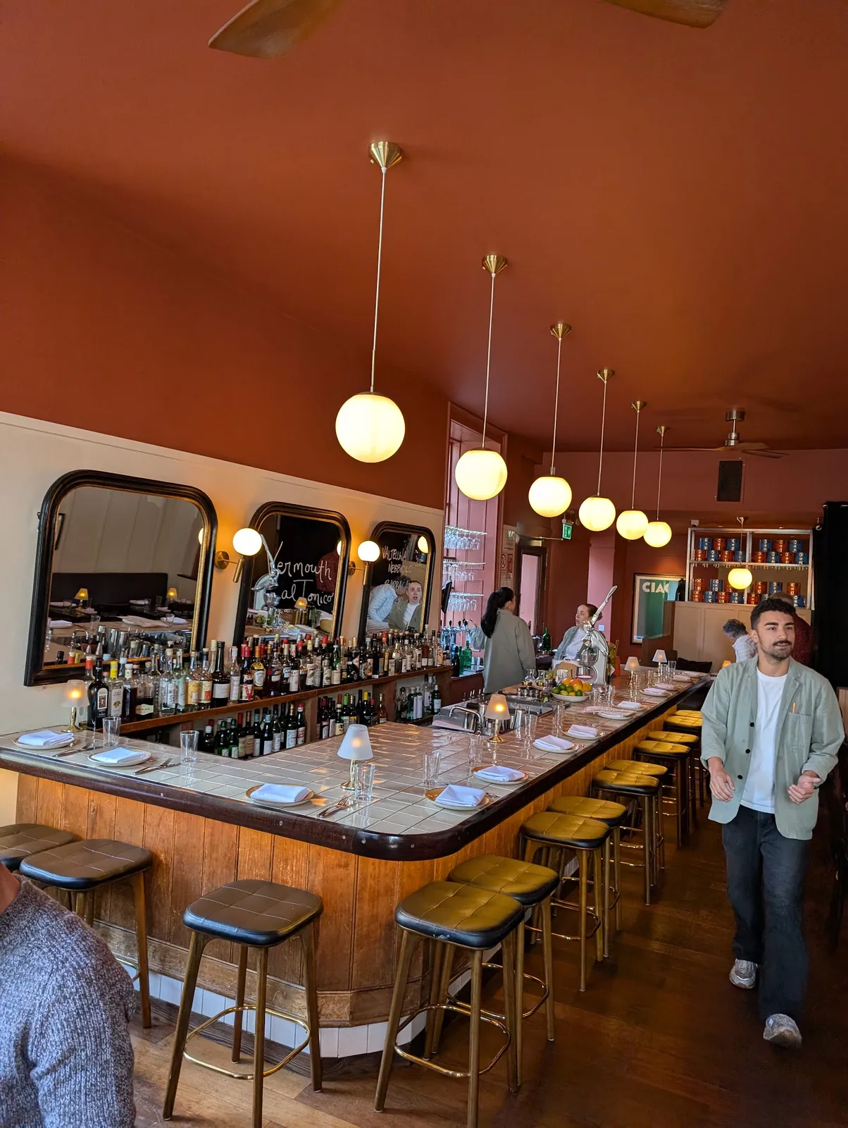 Lively bar interior with warm lighting and full shelves.