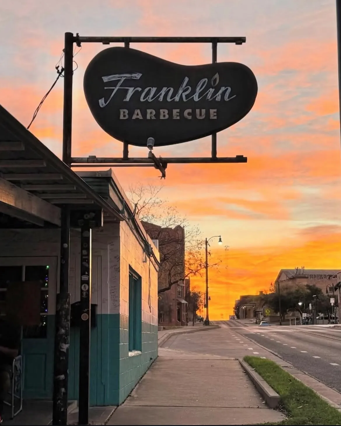 Iconic Franklin Barbecue sign under fiery sunset