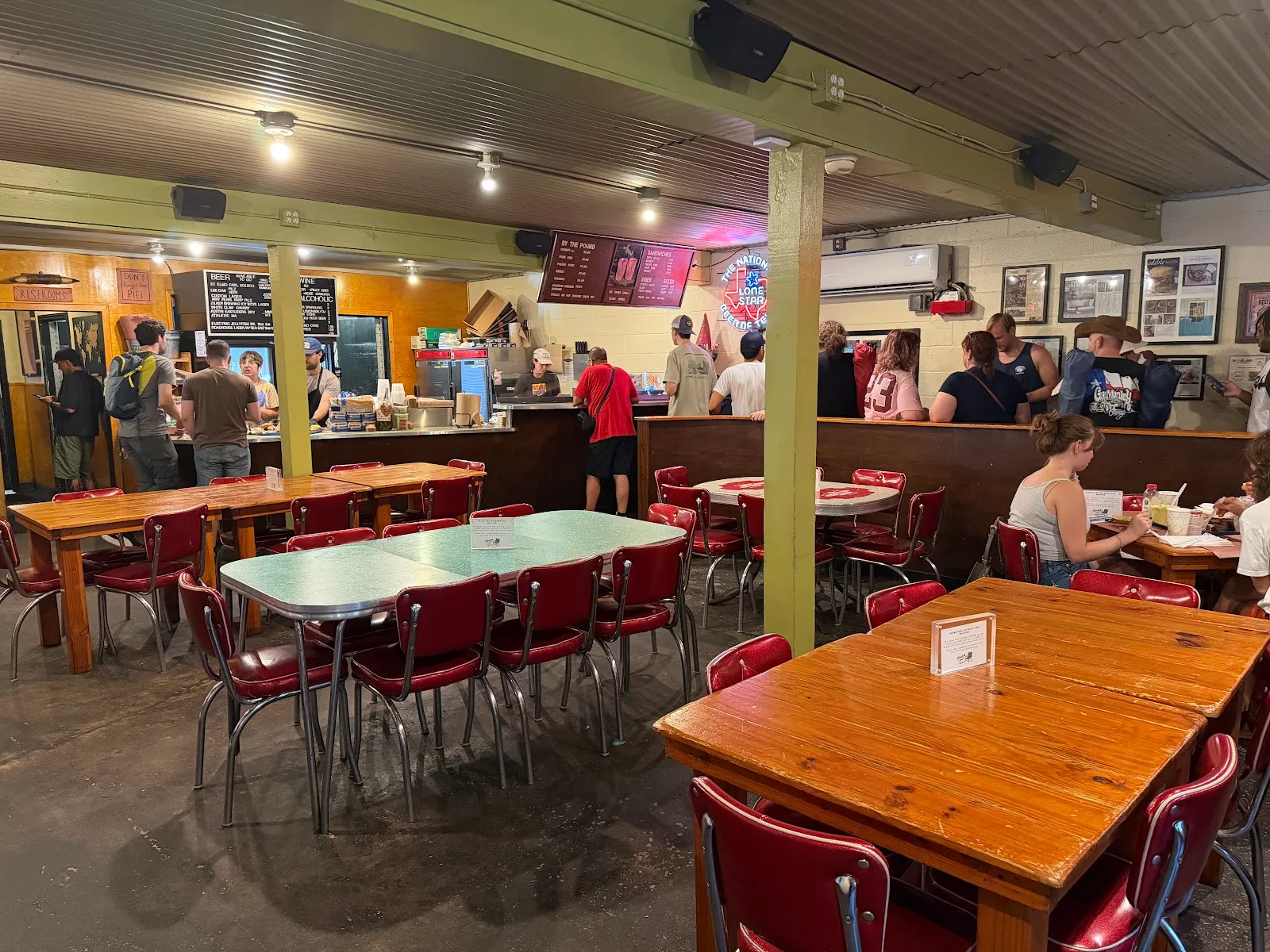 Lively barbecue restaurant interior with red chairs.