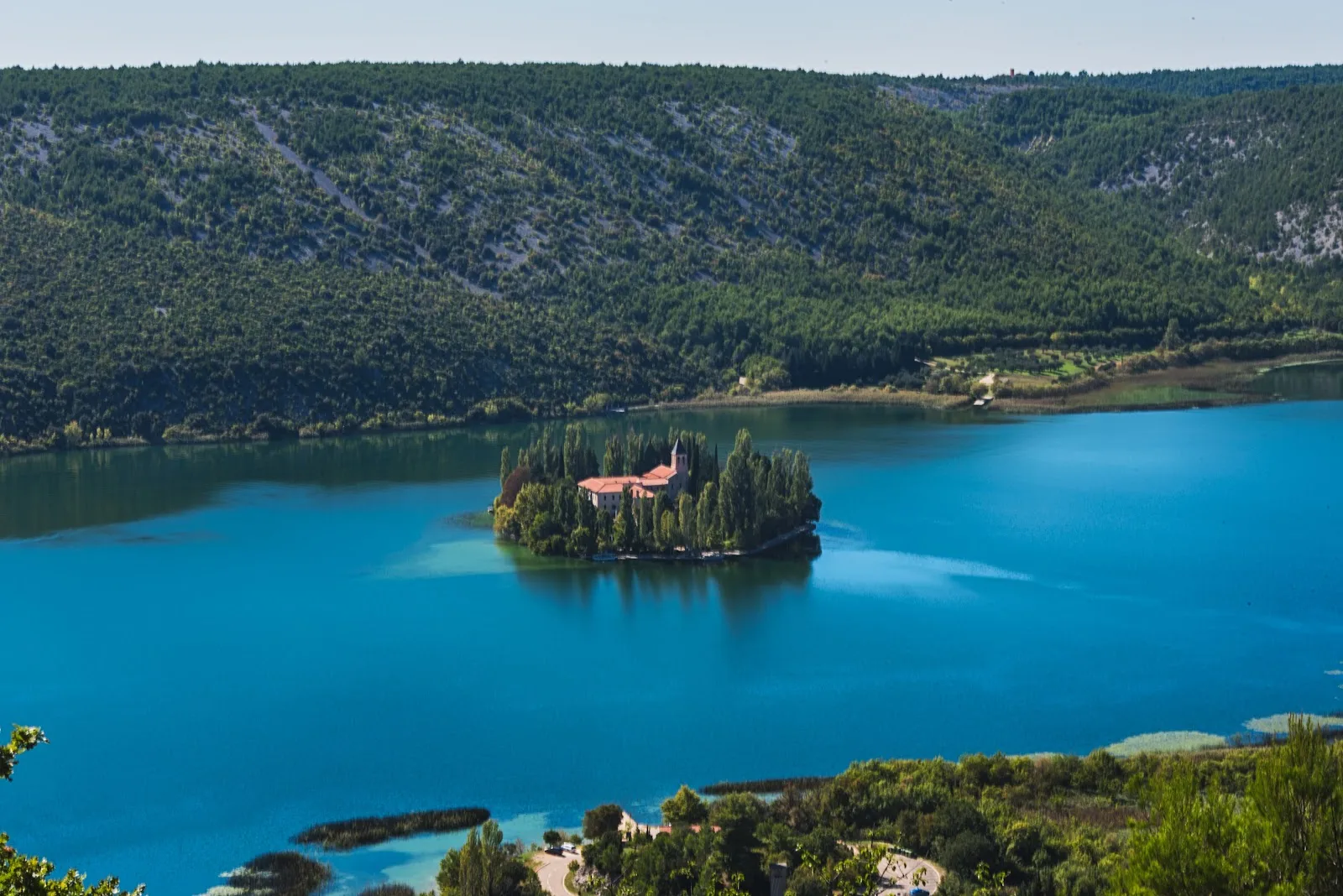 Visovac Monastery island nestled in Krka's serene waters.