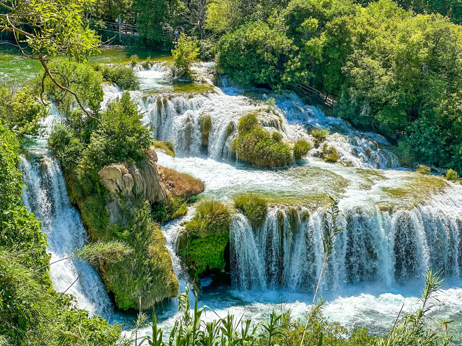 Majestic Skradinski Buk waterfalls cascading through lush greenery.