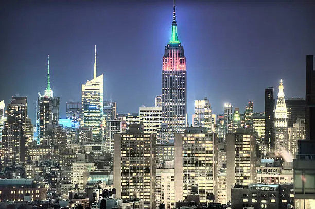 Empire State Building glowing red and green at night
