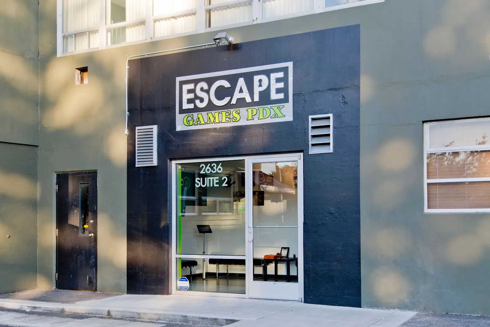 Modern dark facade of Escape Games PDX entrance.