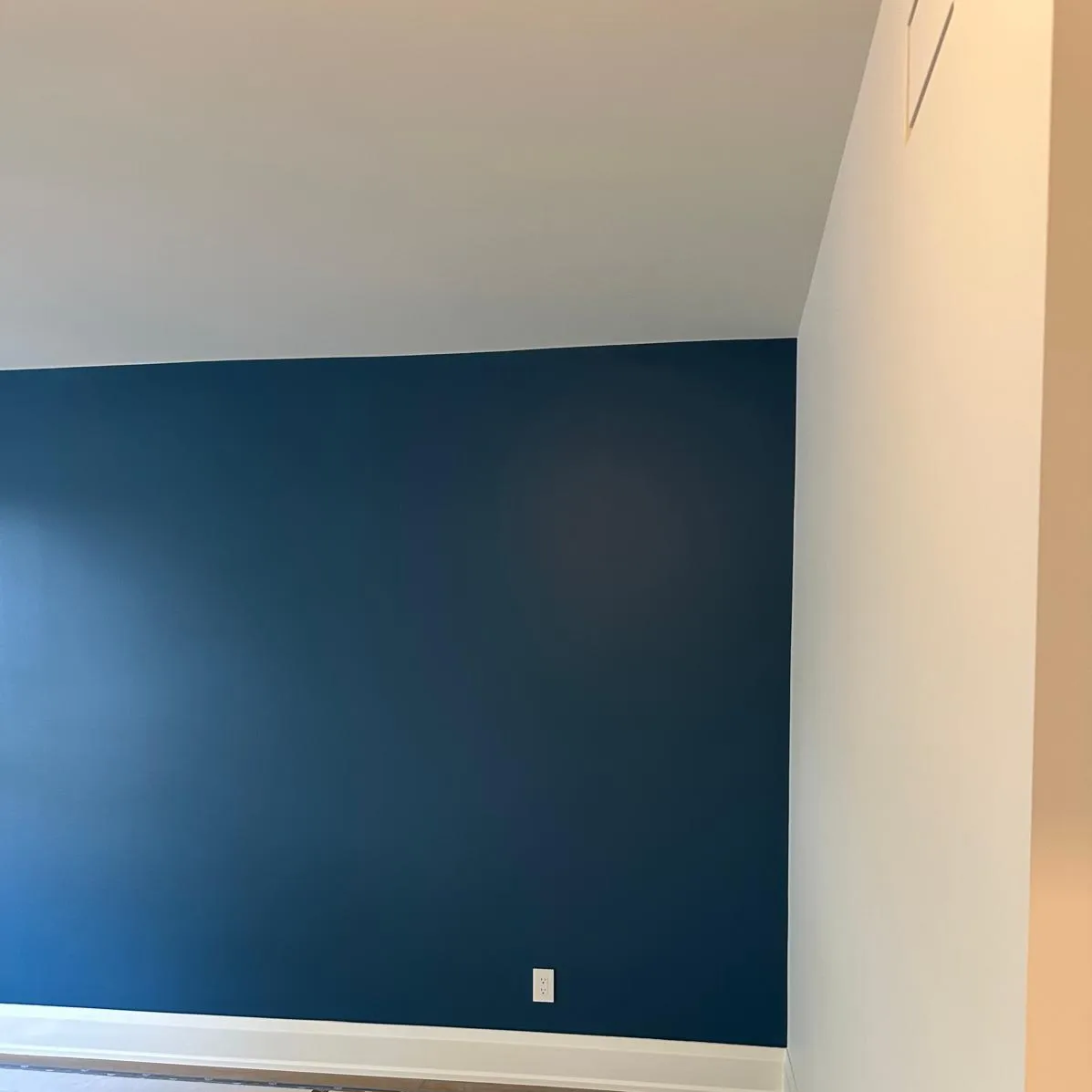 Striking navy blue accent wall with clean lines