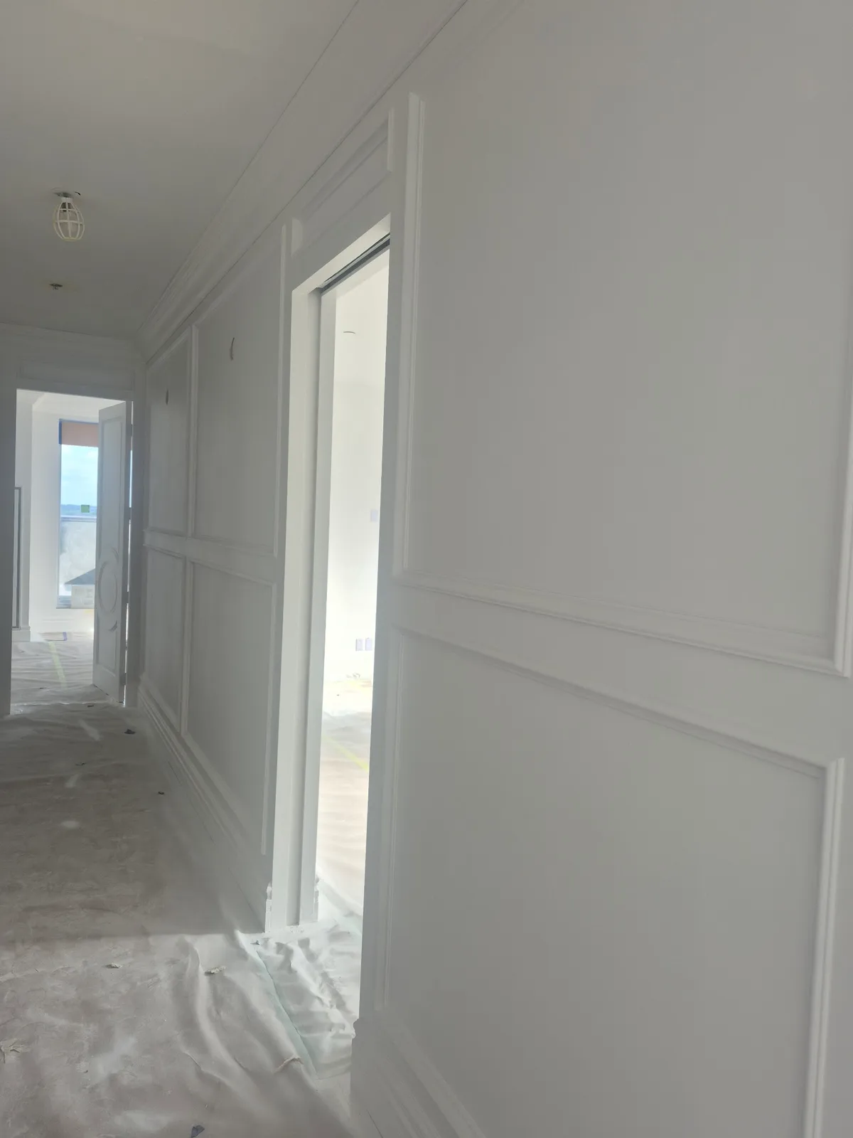 Elegant white wainscoting and trim in hallway